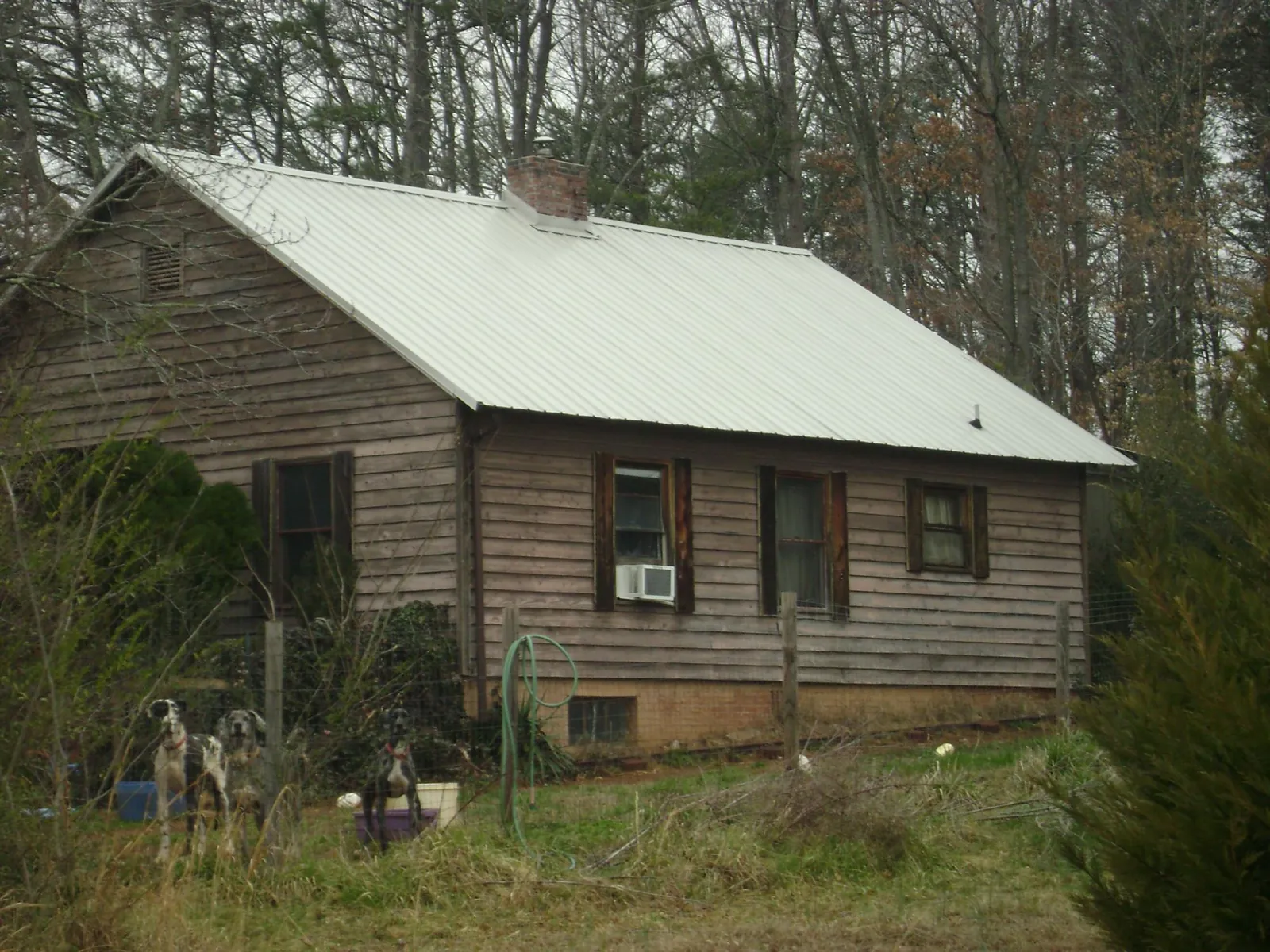 White metal roof on an old wood sided farmhouse, from a Metal Roof Installation job in Plainville